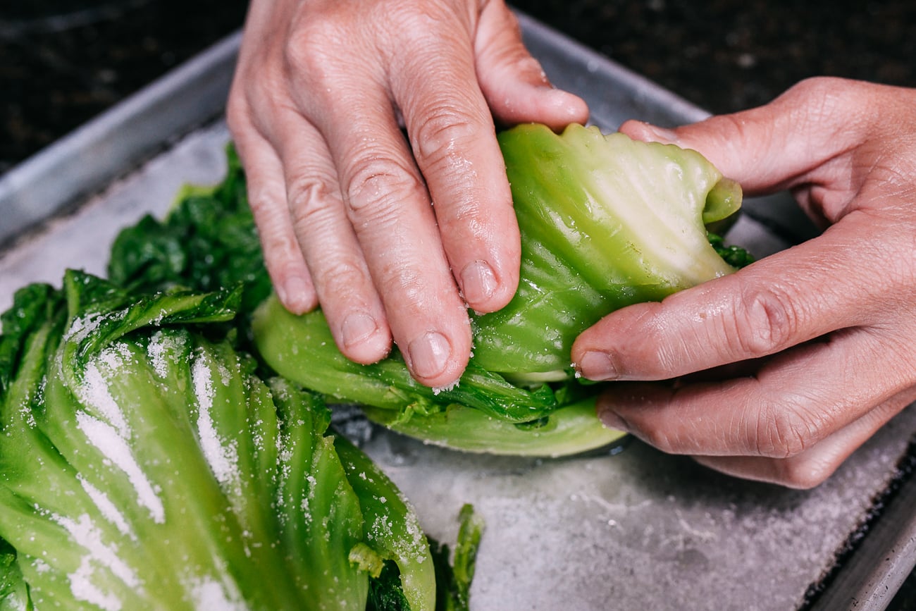 Rubbing salt into mustard greens