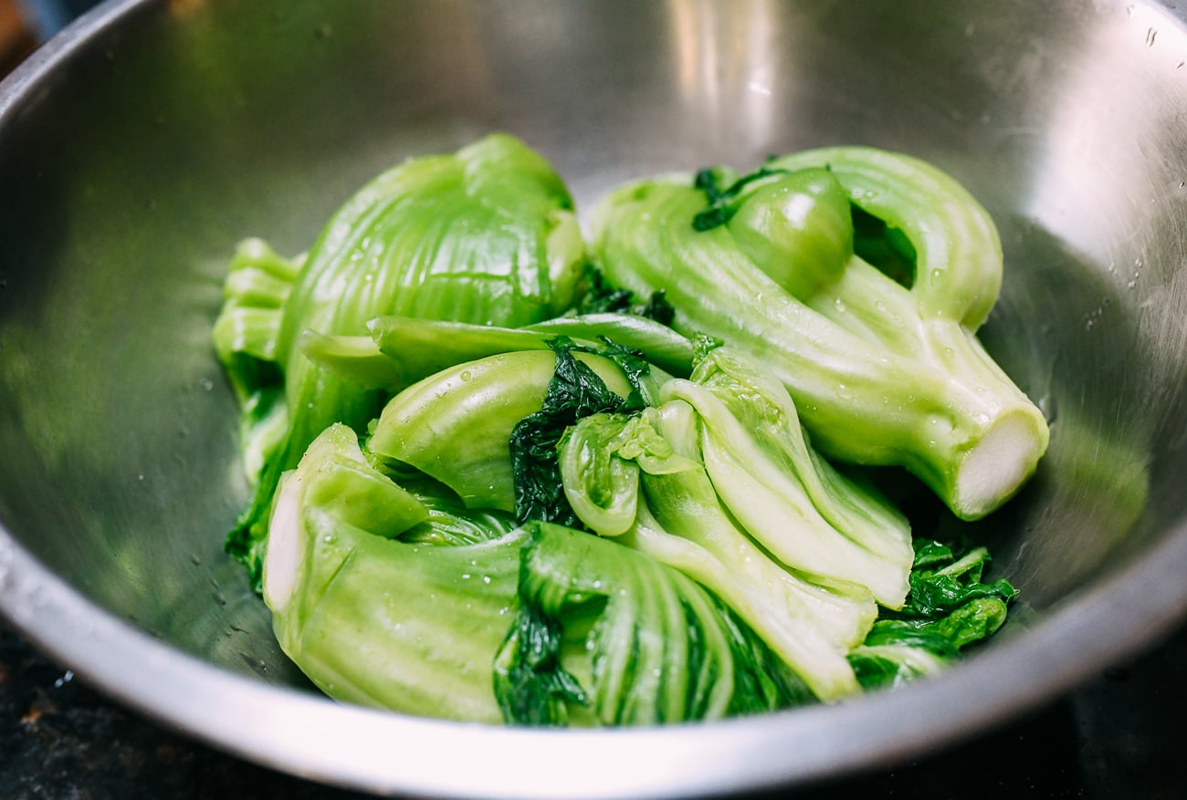 Blanched salted mustard greens in stainless steel bowl