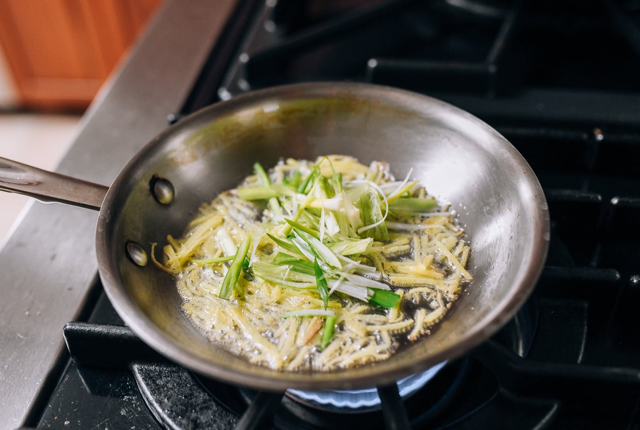 Adding white parts of scallions to ginger
