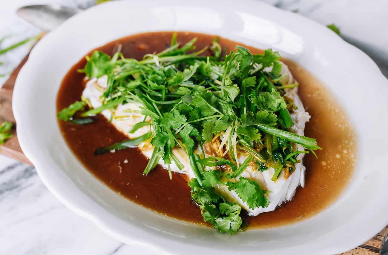 Raw aromatics over the top of sauced fish