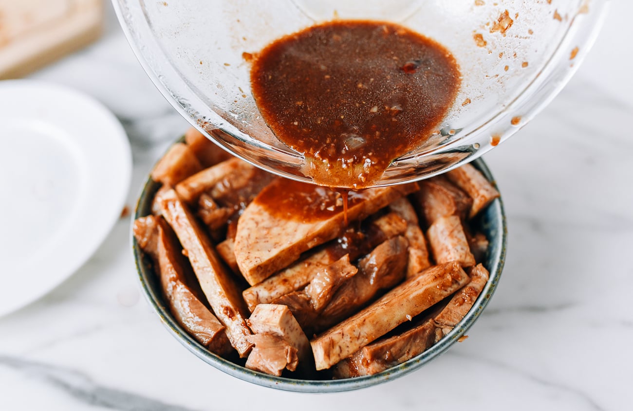 Pouring marinade over taro and pork belly