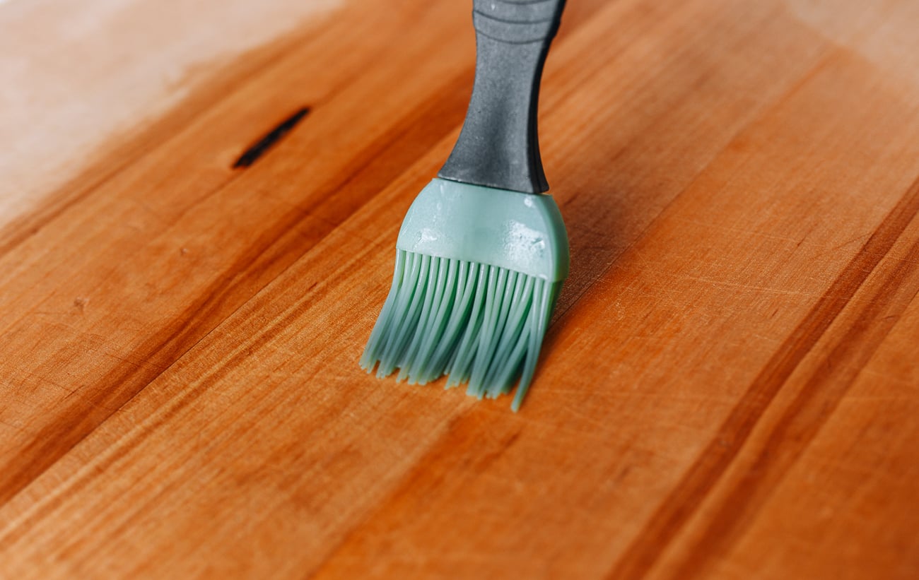 Brushing cutting board with oil