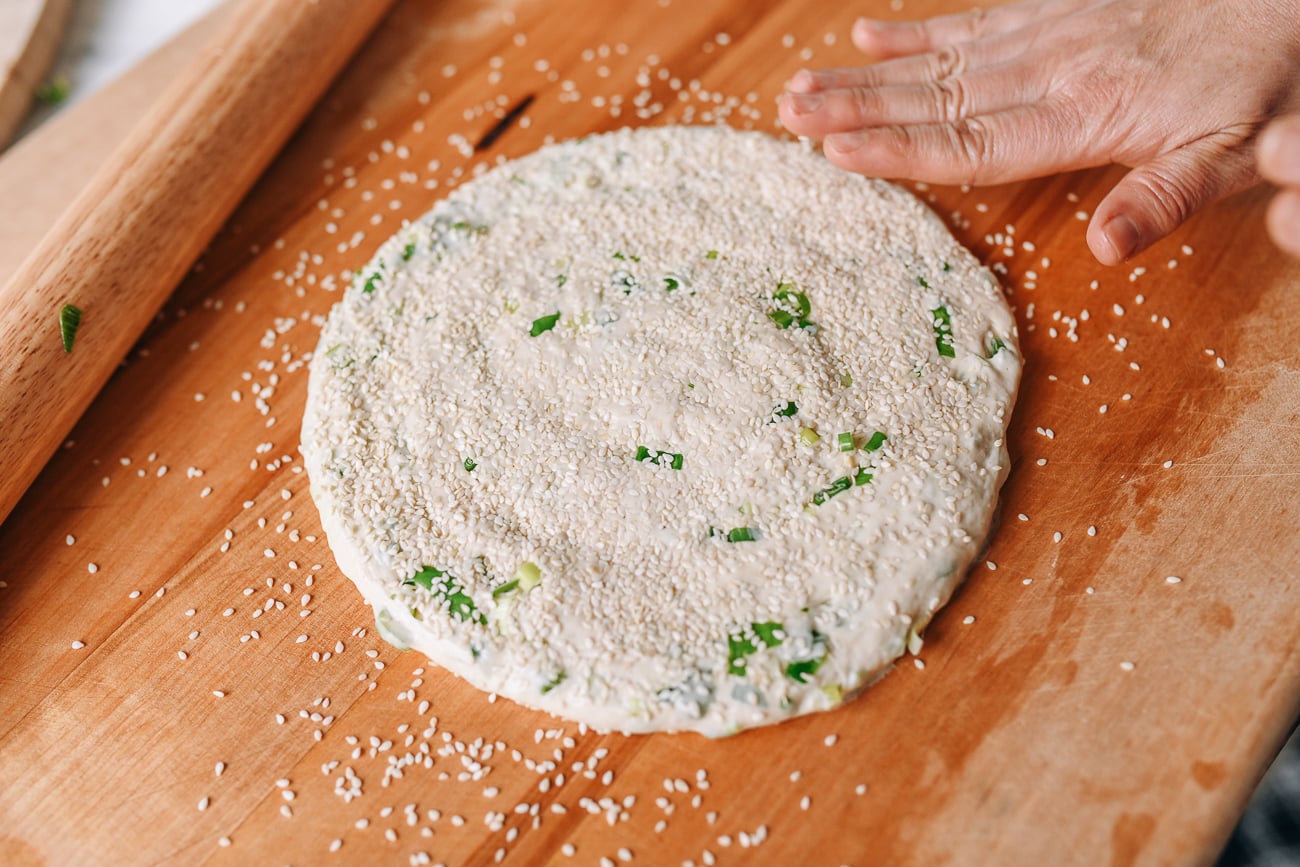 Pressing sesame seeds into dough