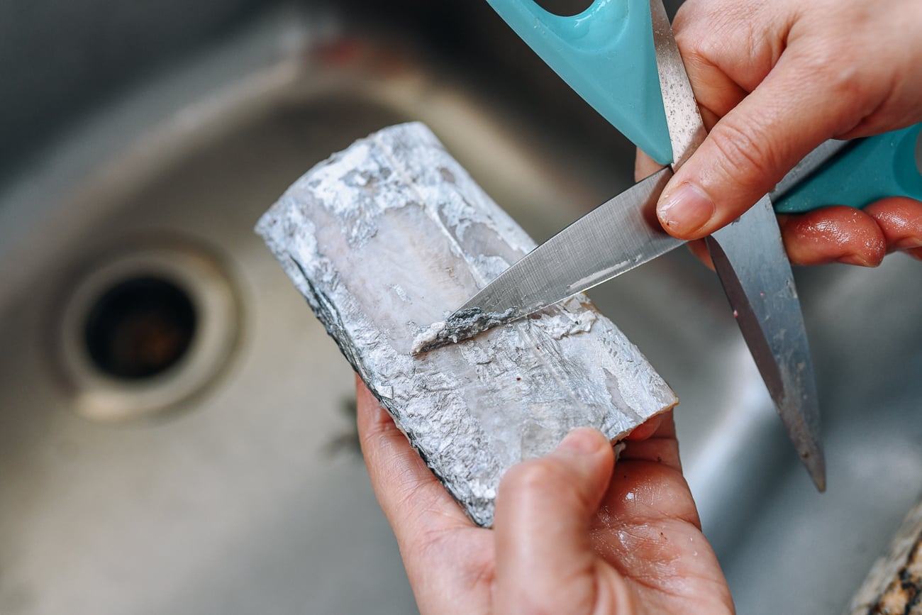 Scraping skin off of belt fish