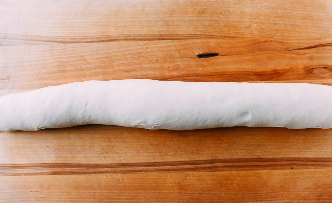 Filled cinnamon roll dough before cutting
