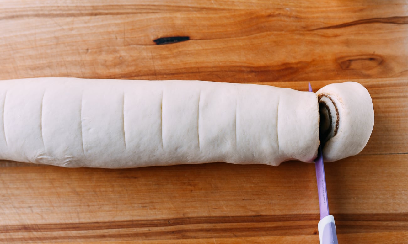 Cutting cinnamon rolls