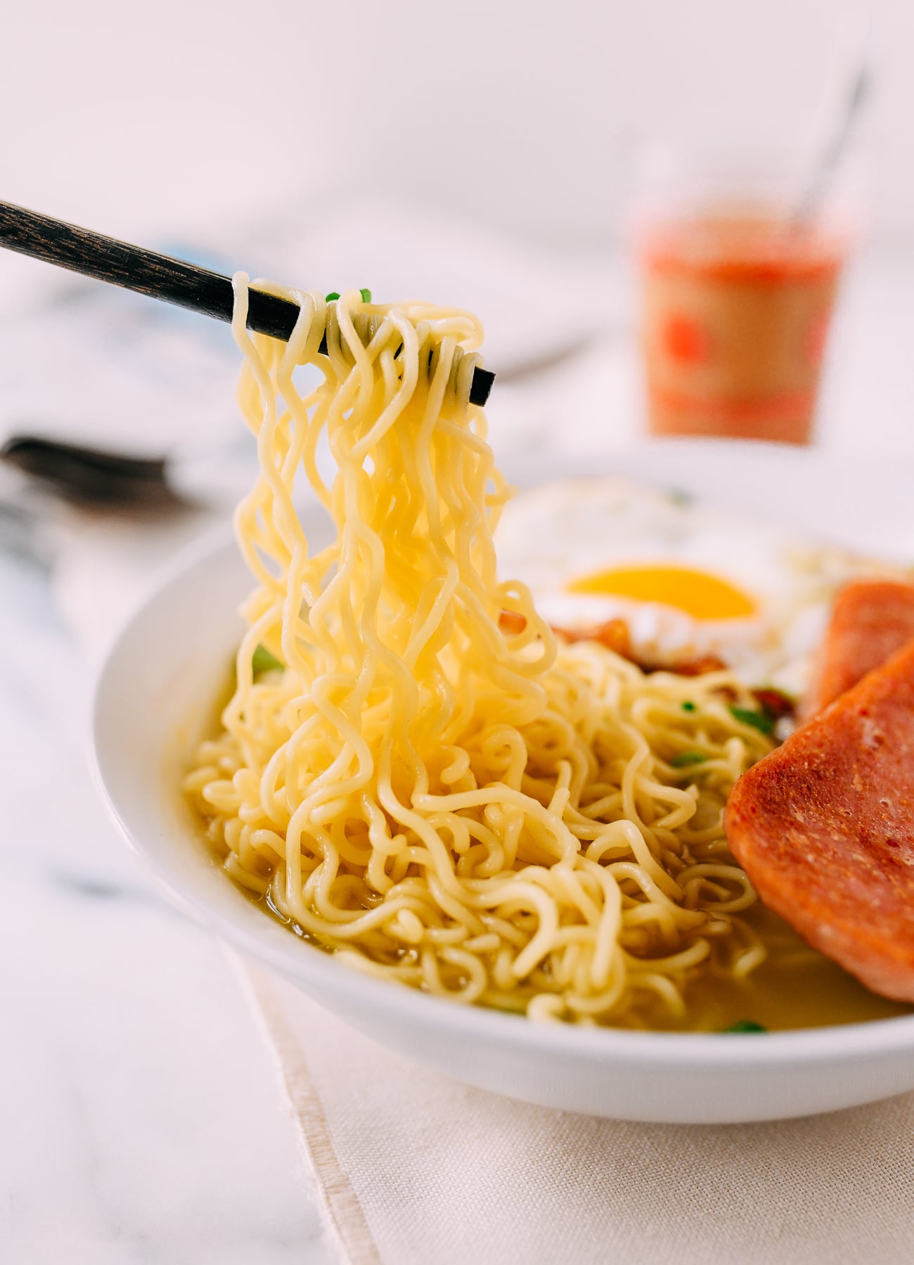 Pulling up noodles from a bowl of Hong Kong Instant Noodles