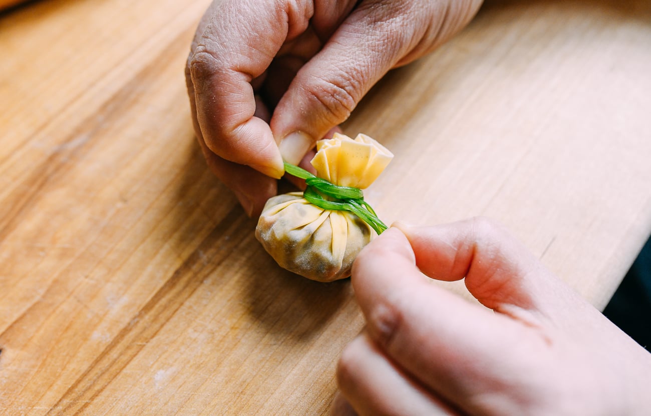 Using cilantro to tie dumpling closed