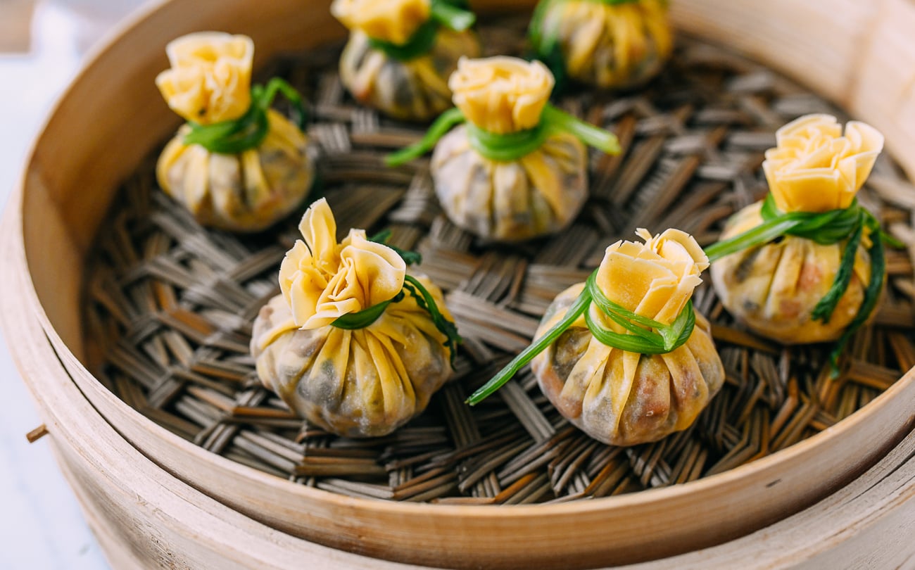 Money bag dumplings in bamboo steamer before cooking