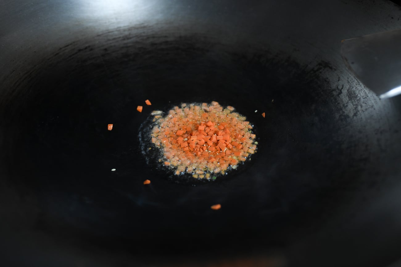 Cooking carrots and ginger in wok