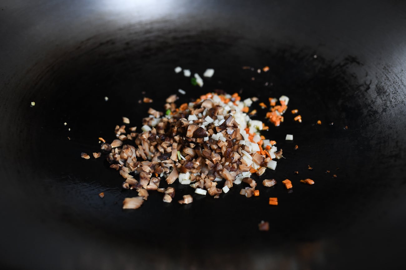 Adding mushrooms and bamboo shoots to carrots and ginger