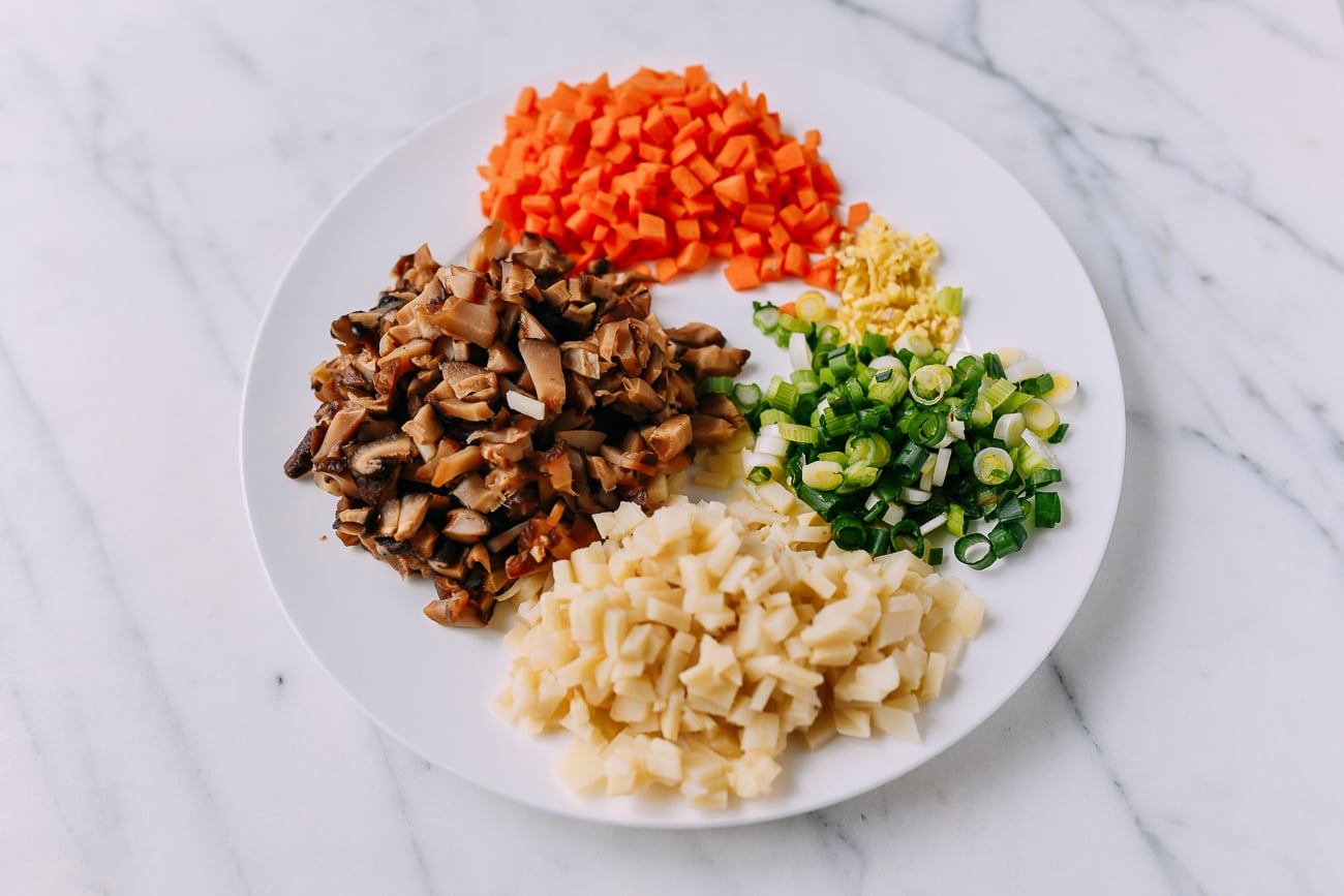 Chopped carrots, ginger, scallions, bamboo shoots, and shiitake mushrooms