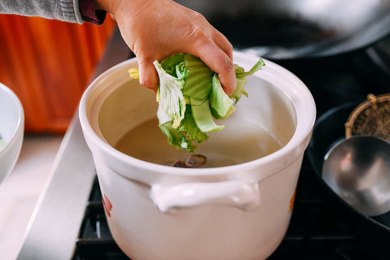 Adding mustard greens to soup