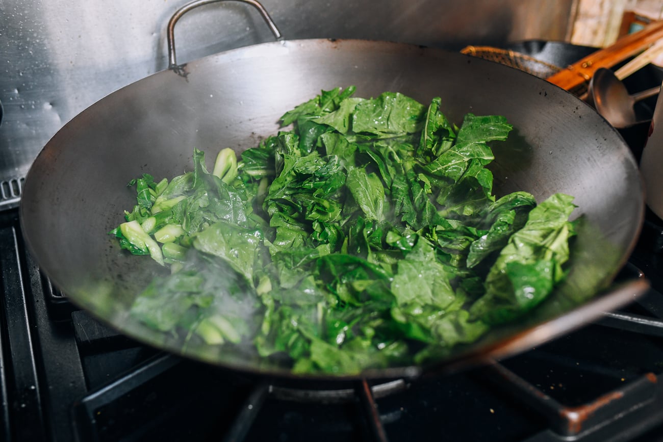 Adding Chinese broccoli to wok