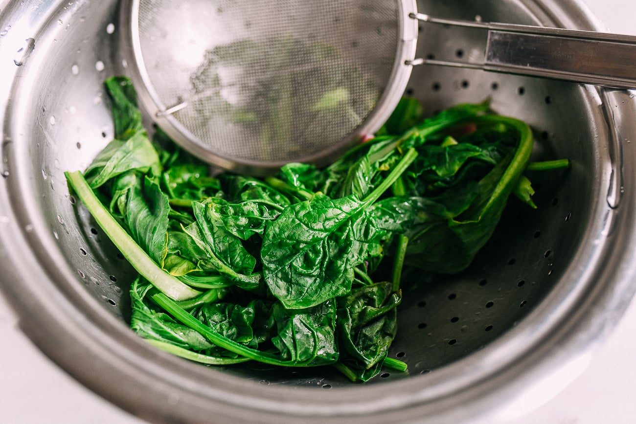 Blanched spinach in colander