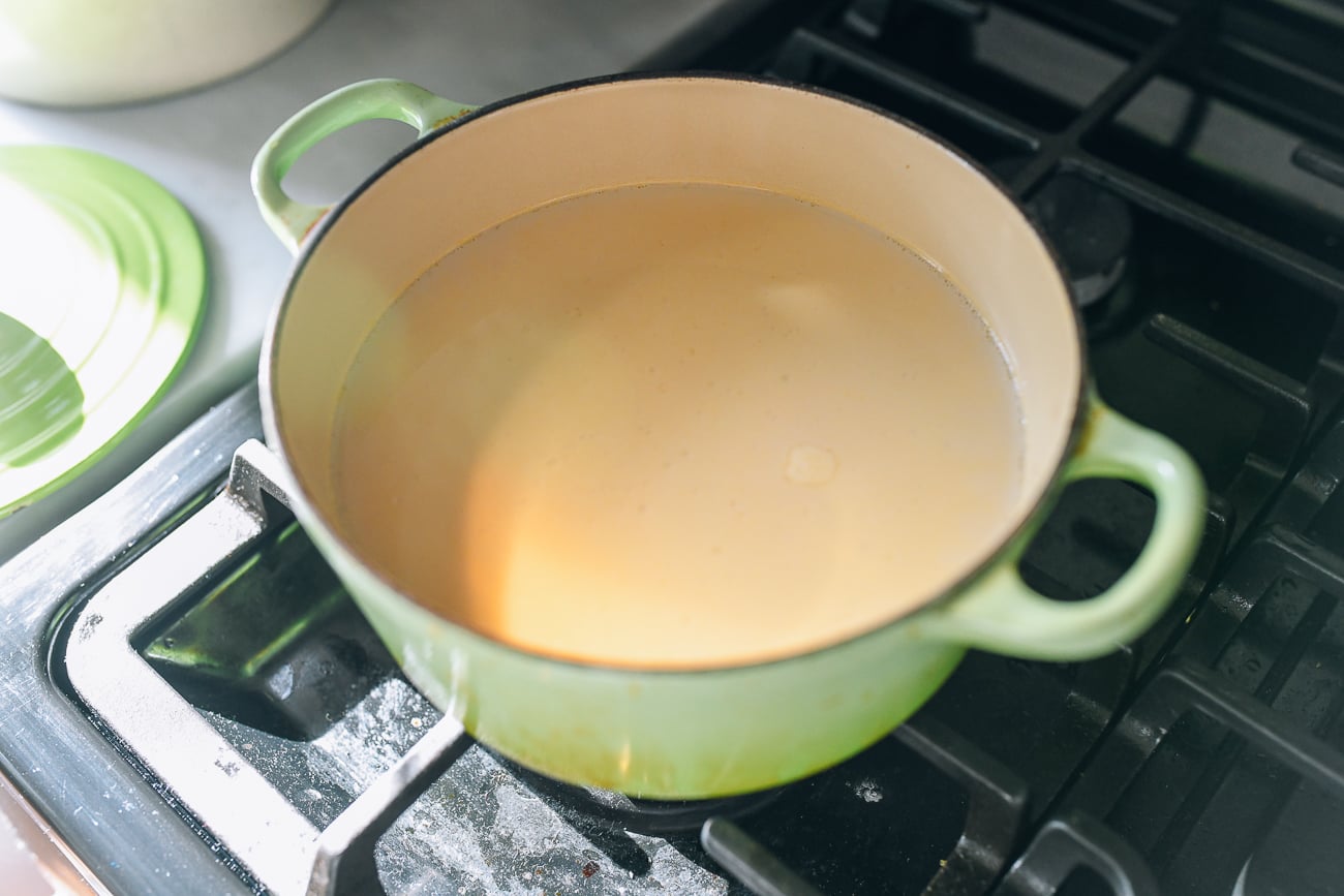 Stock and oat milk in pot