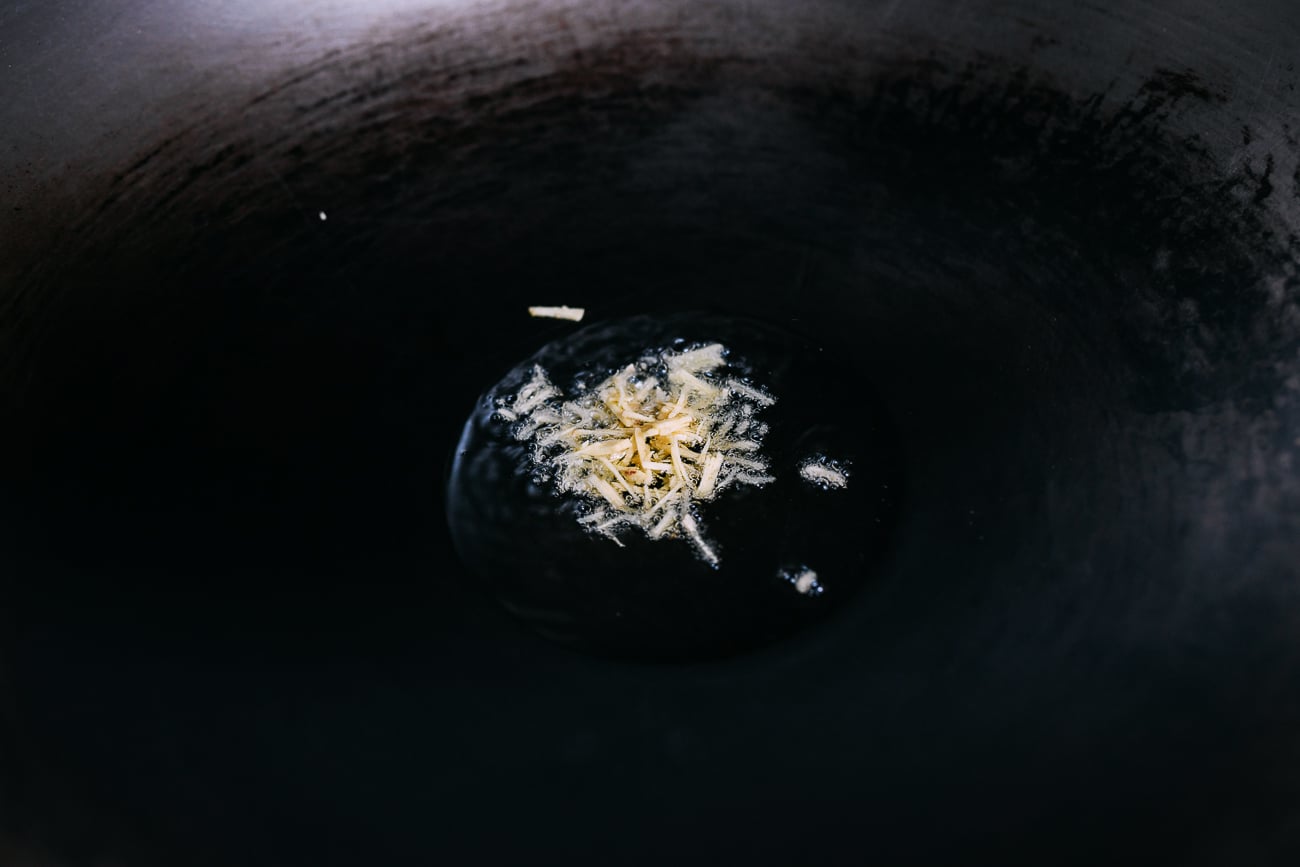Ginger cooking in oil in wok