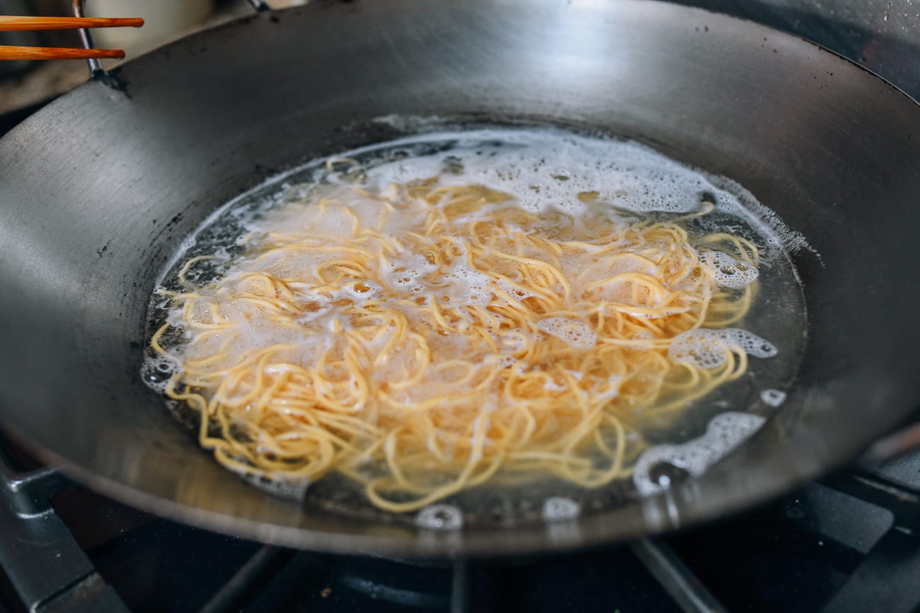 boiling lo mein noodles in wok