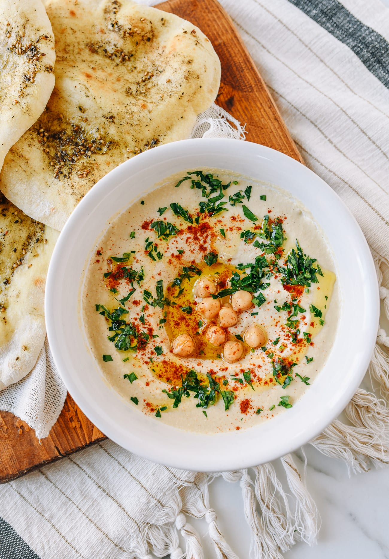 Hummus in white dish with laffa bread