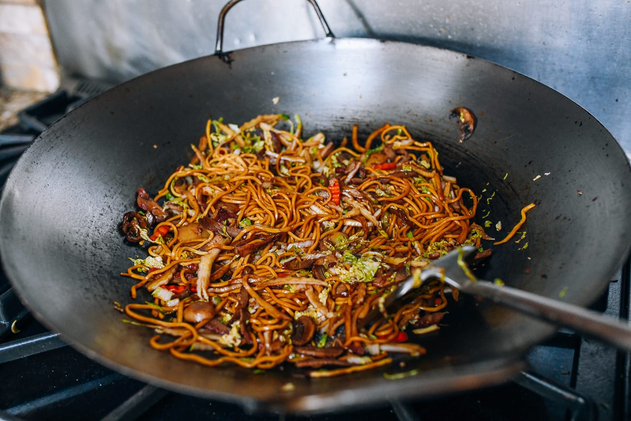 stir-frying lo mein in wok