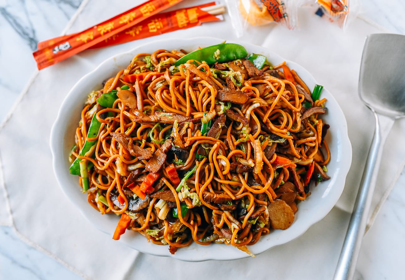 Plate of Roast Pork Lo Mein with chopsticks and fortune cookies