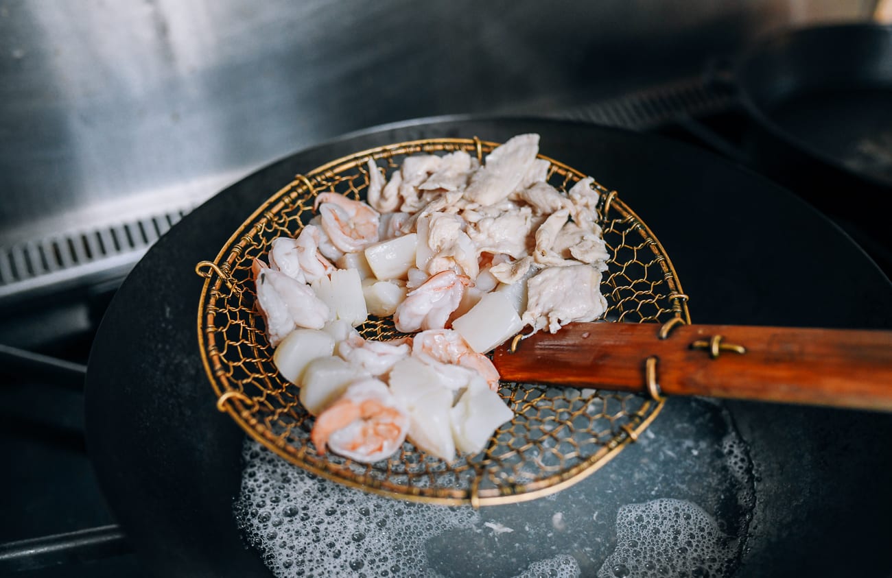 Removing blanched shrimp, scallops, and chicken from boiling water using spider strainer