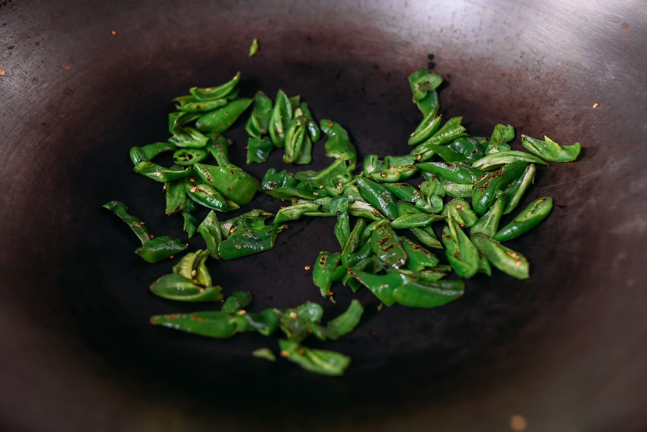 Dry frying peppers in wok