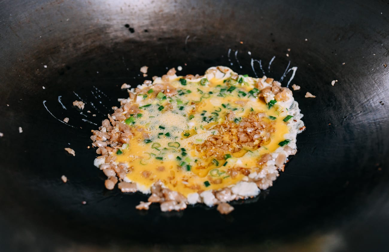 Adding eggs on top of preserved radish