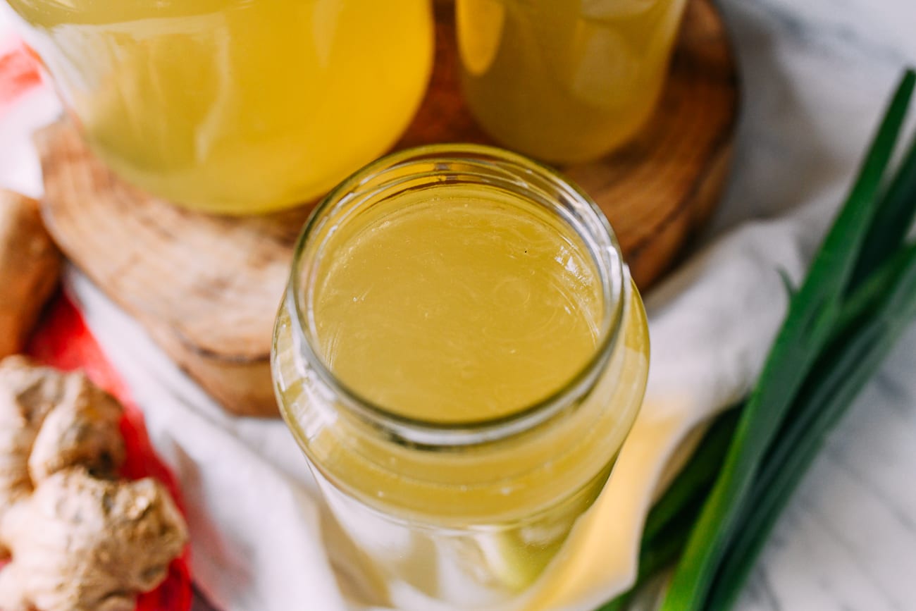 Clear chicken broth stored in glass jar