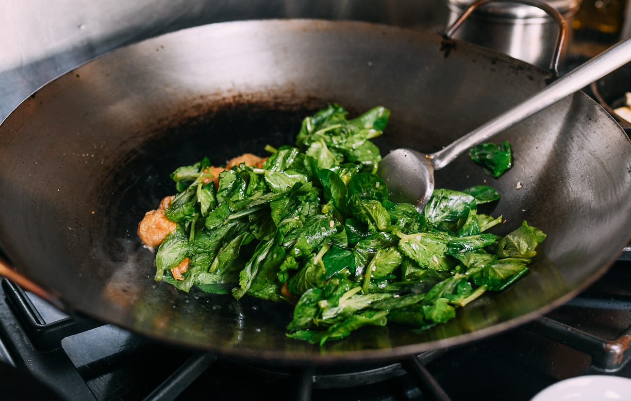 Stirring pea tips in wok