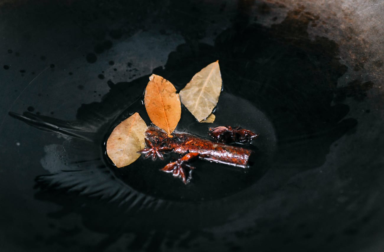 Infusing oil with cinnamon stick, star anise, and bay leaves