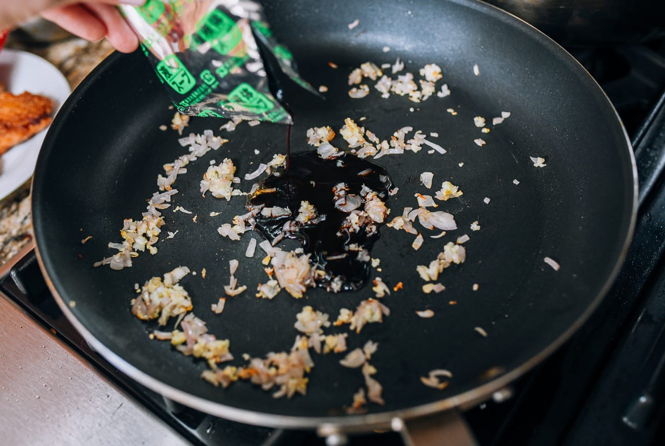 Adding sauce packet to shallots and garlic