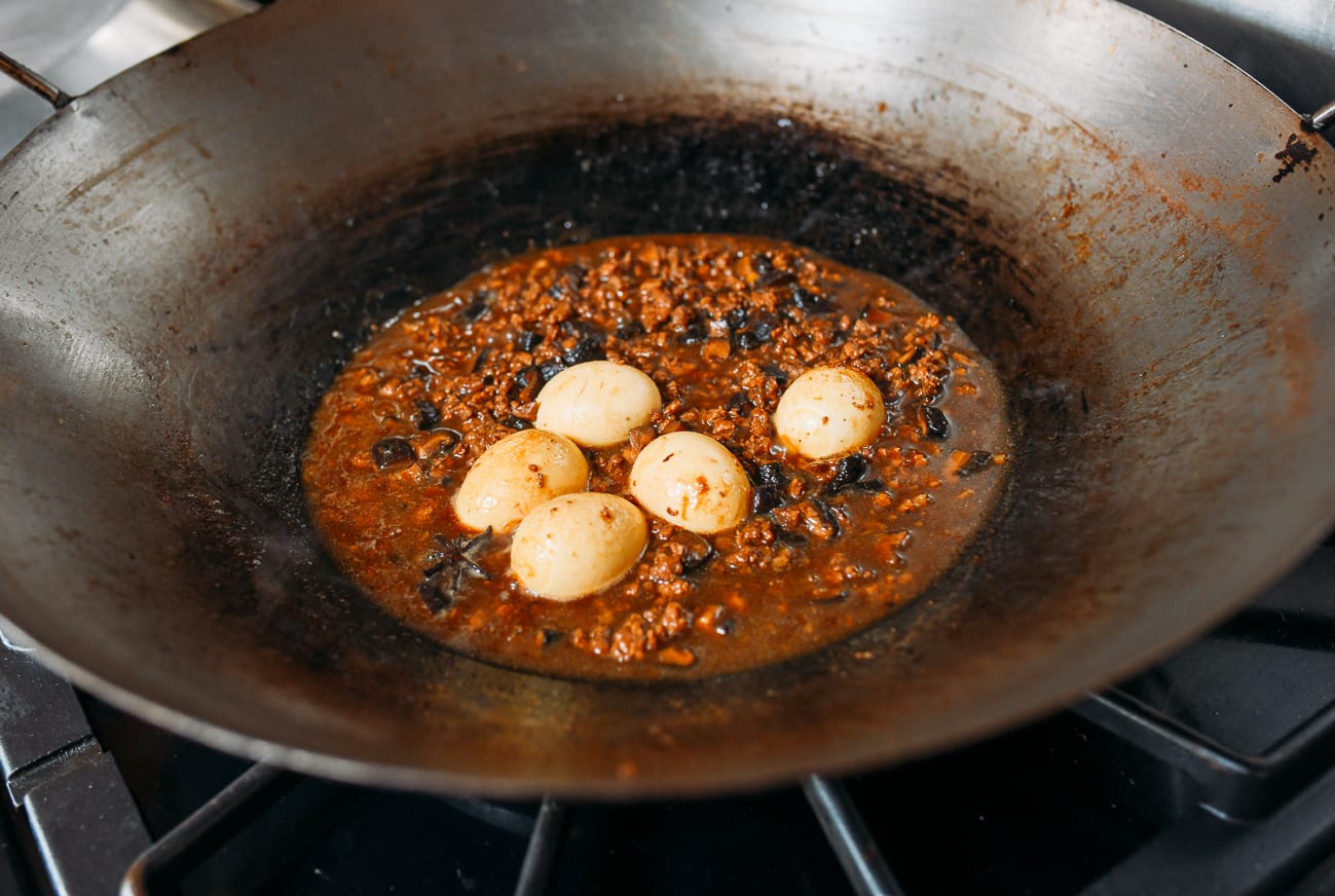 Adding eggs to pork mixture