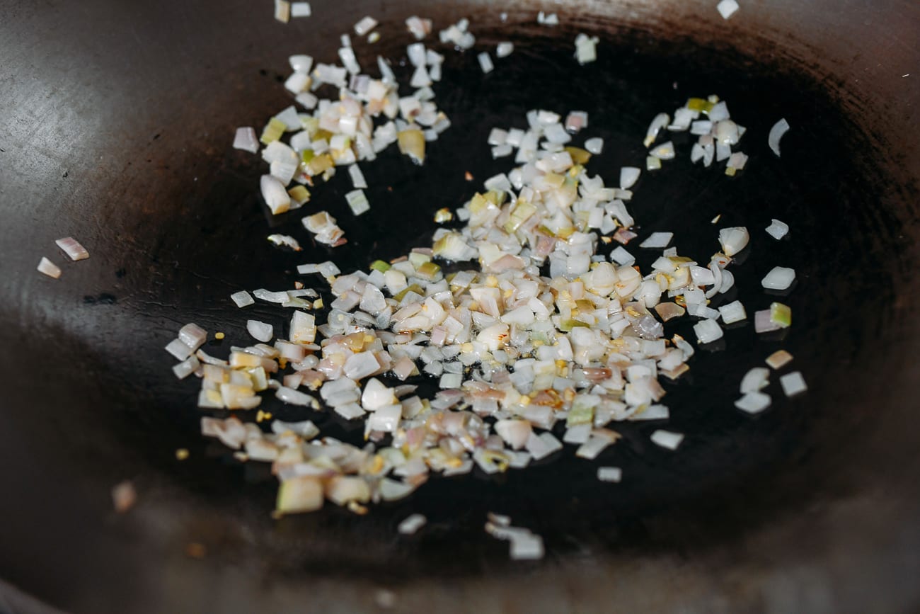 Cooking shallots and ginger in wok