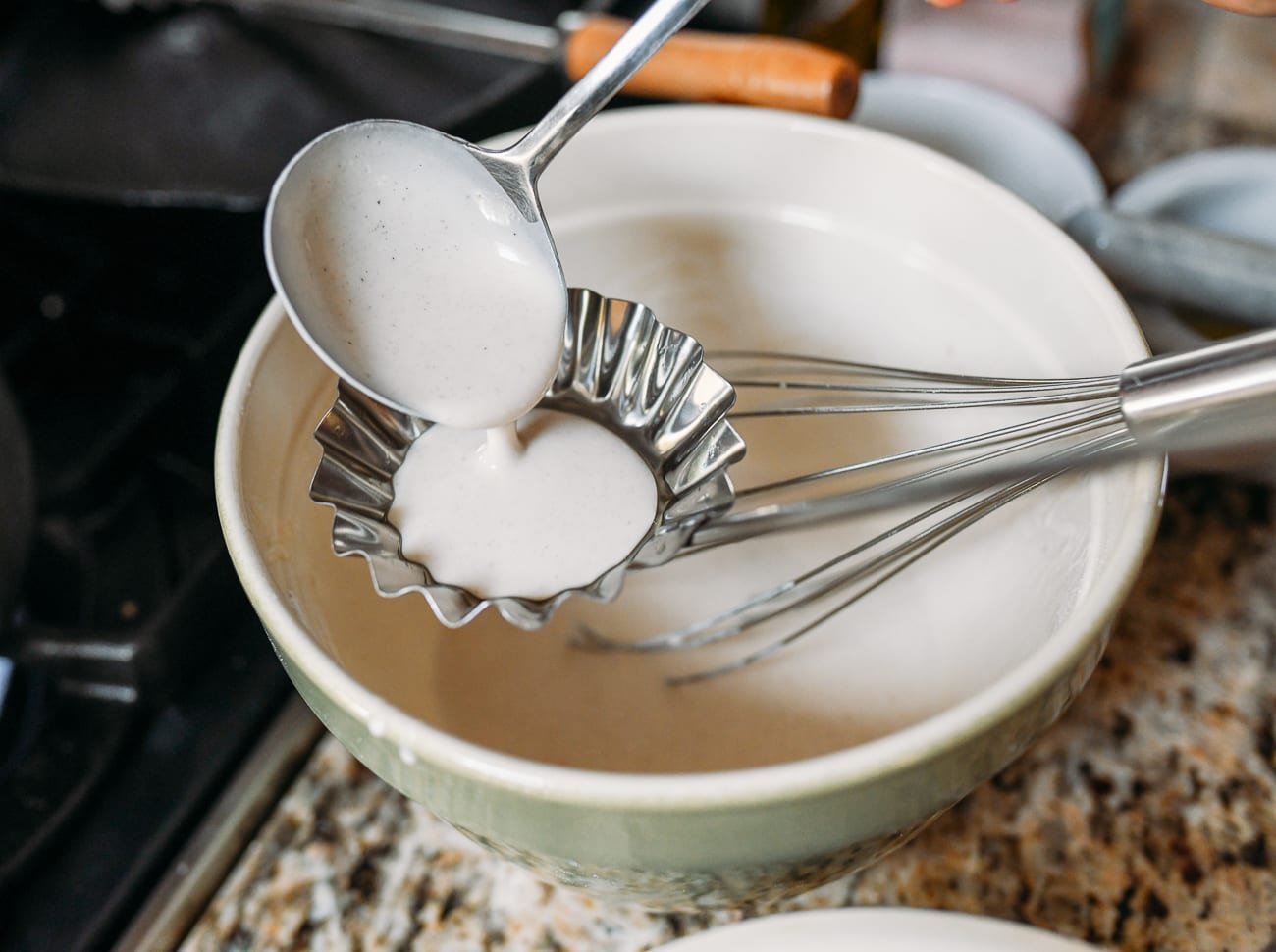Adding thin layer of batter to hot ladle