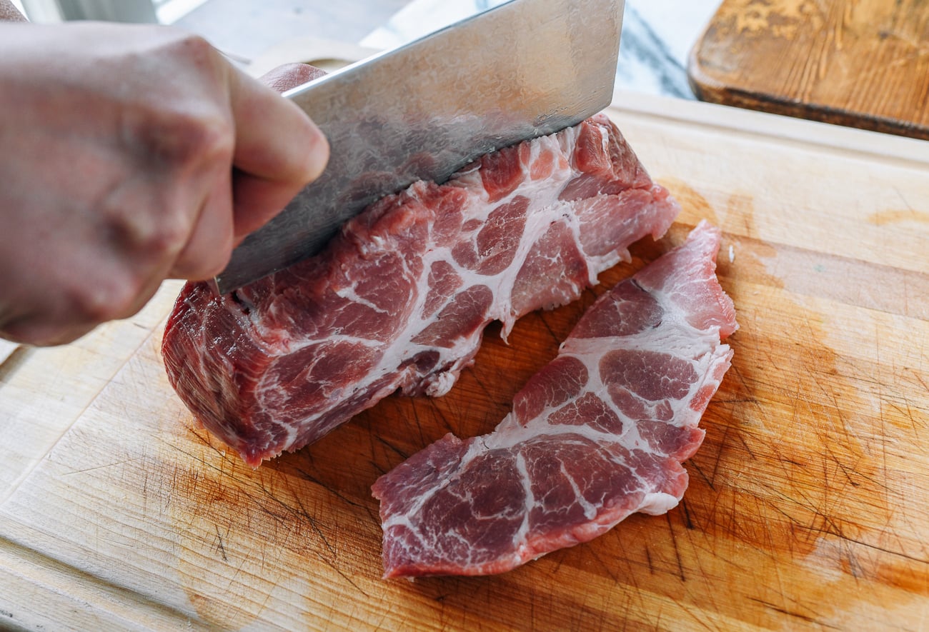 Slicing pork but into large slabs
