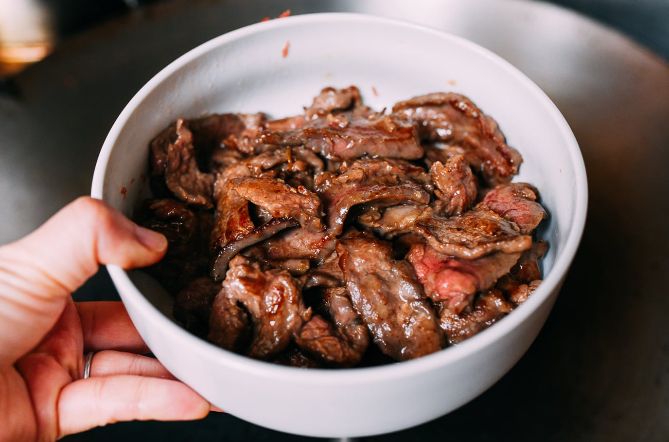 Removing seared beef from wok