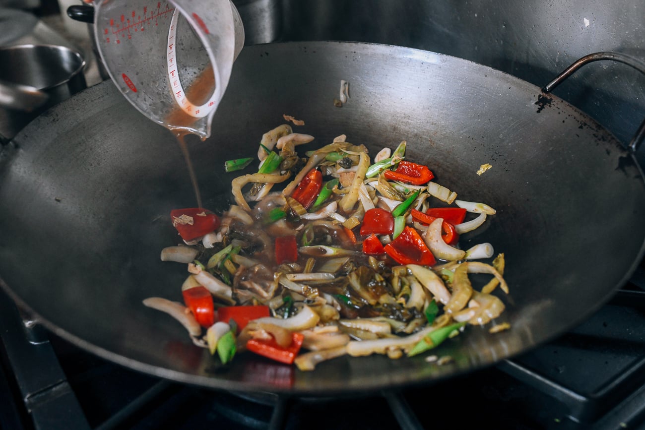 Adding Shaoxing wine to wok