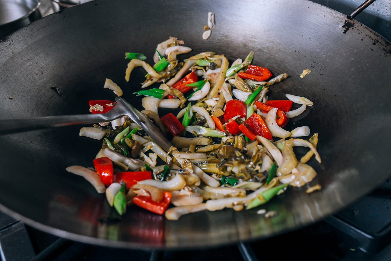 Stir-frying haam choy and vegetables