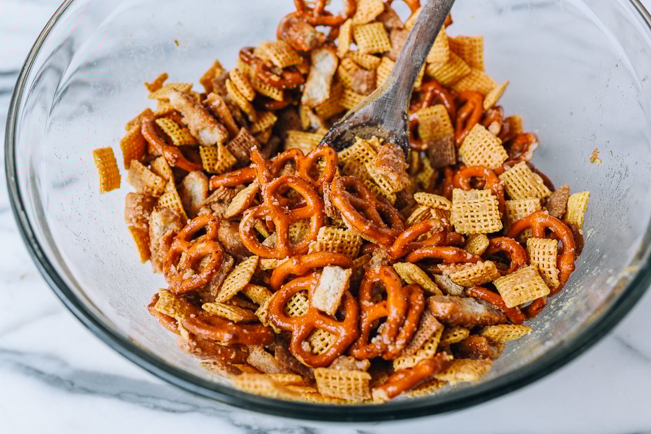 Stirring seasoning into snack mix
