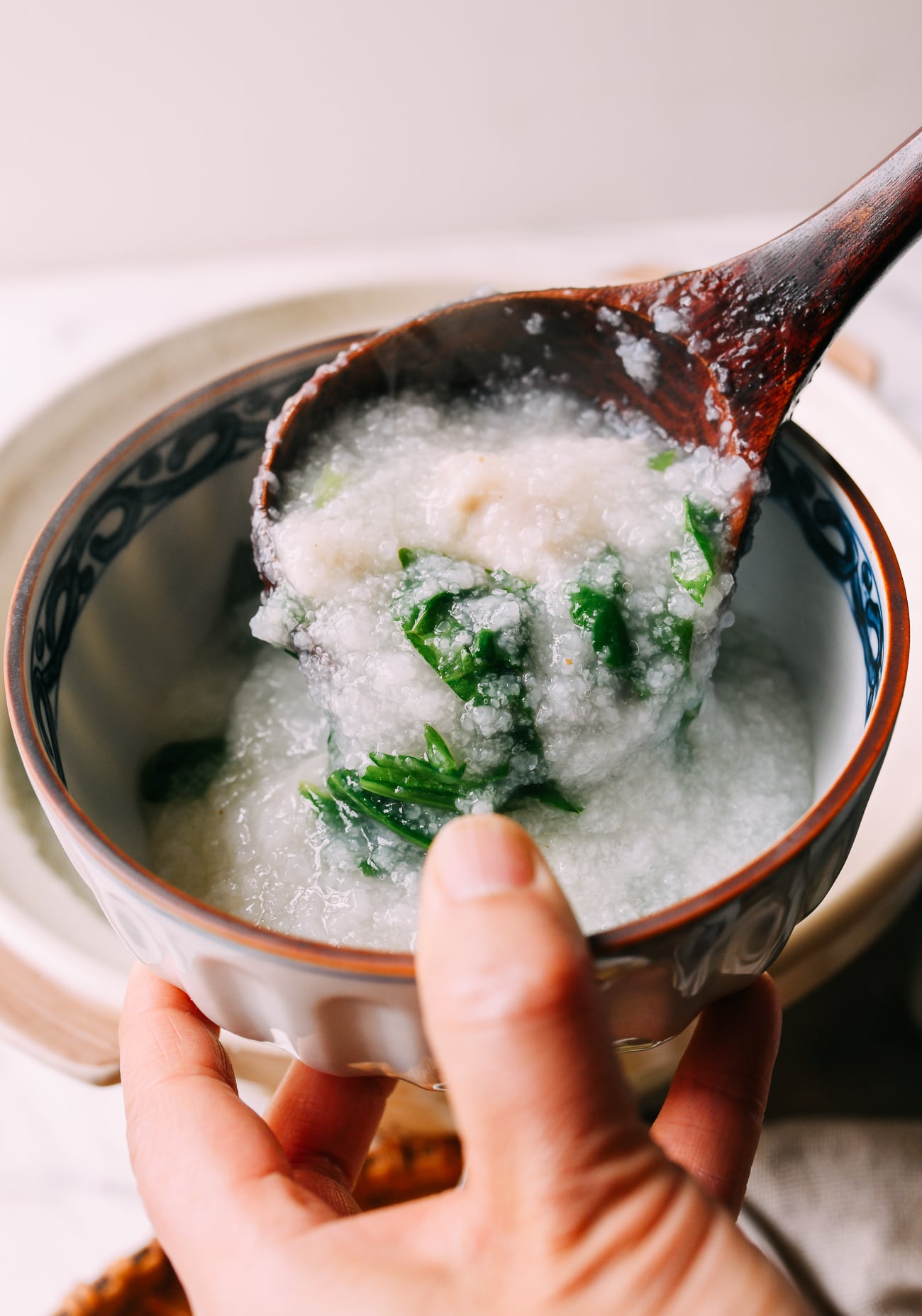 Doling out fish congee into bowl