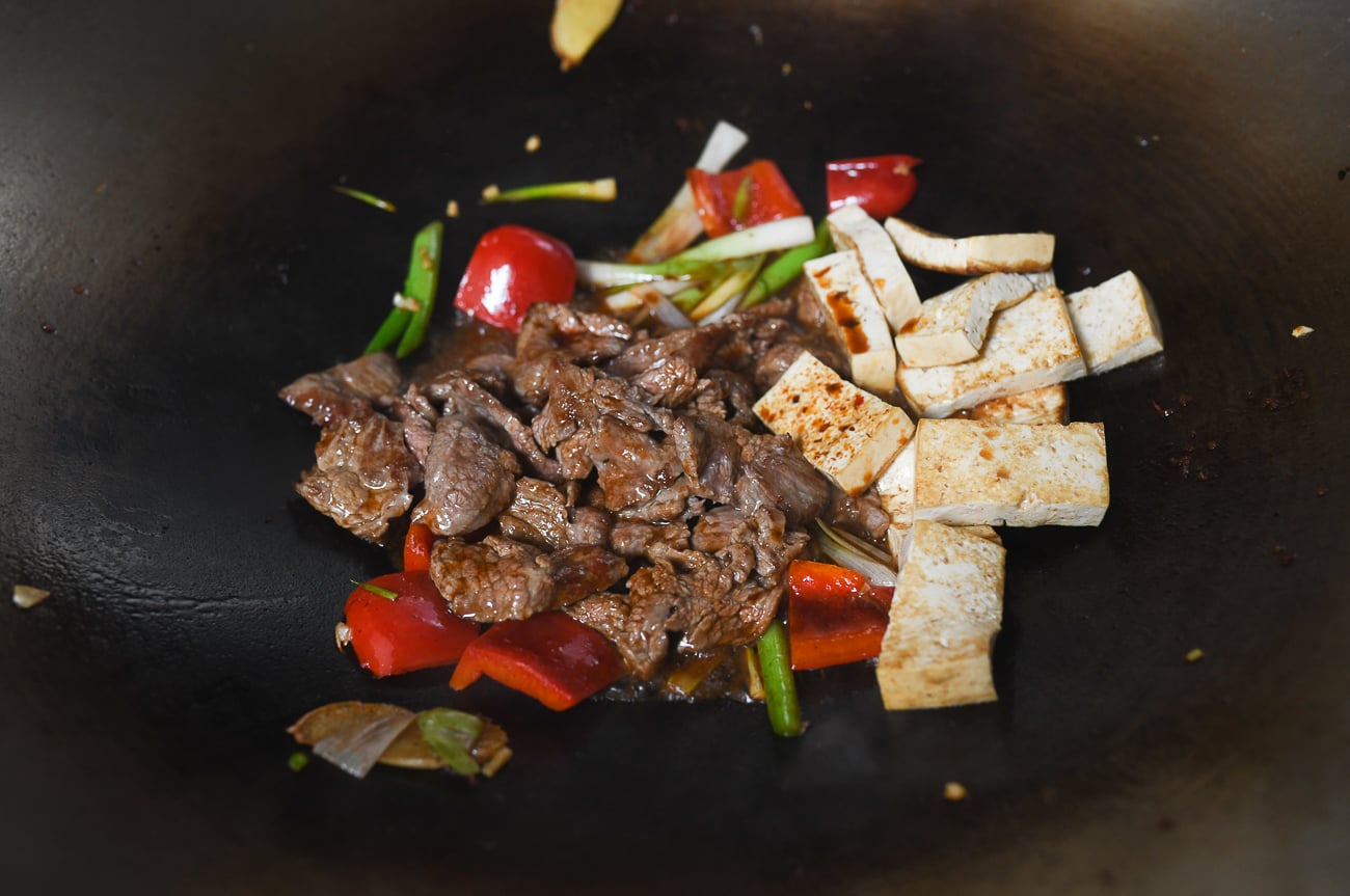 vegetables, beef, and tofu in wok