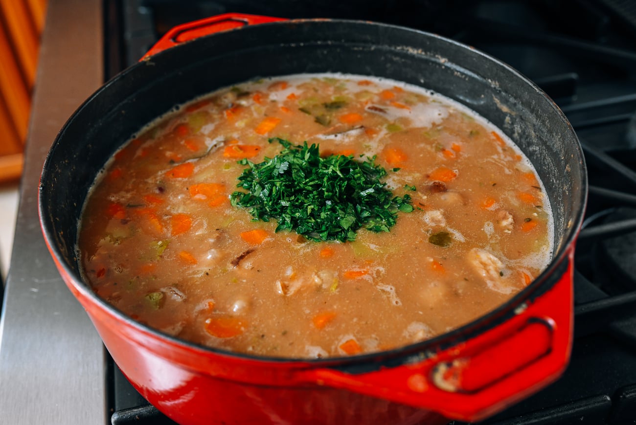 Adding fresh parsley to ham and bean soup