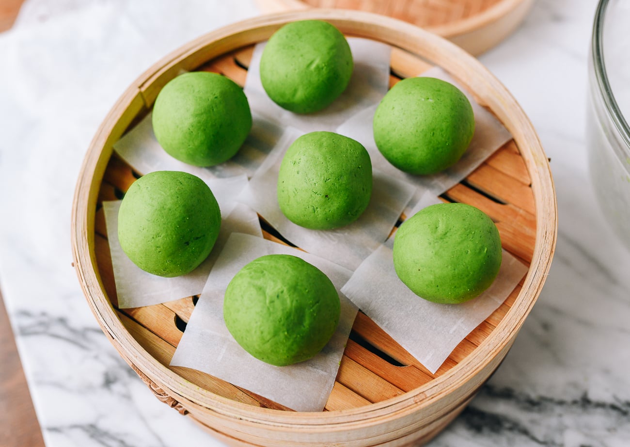 Qingtuan on parchment paper in bamboo basket