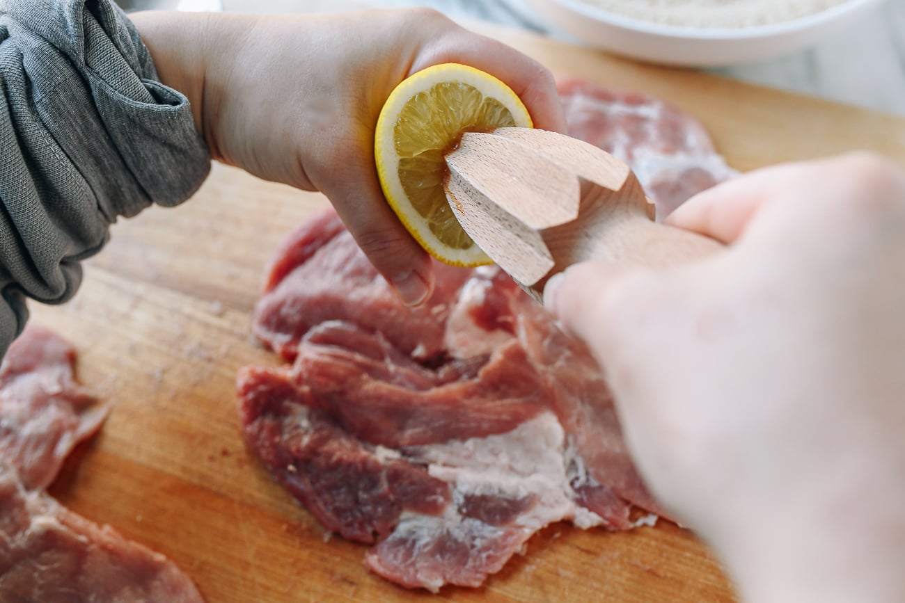 Juicing lemon over pork chop