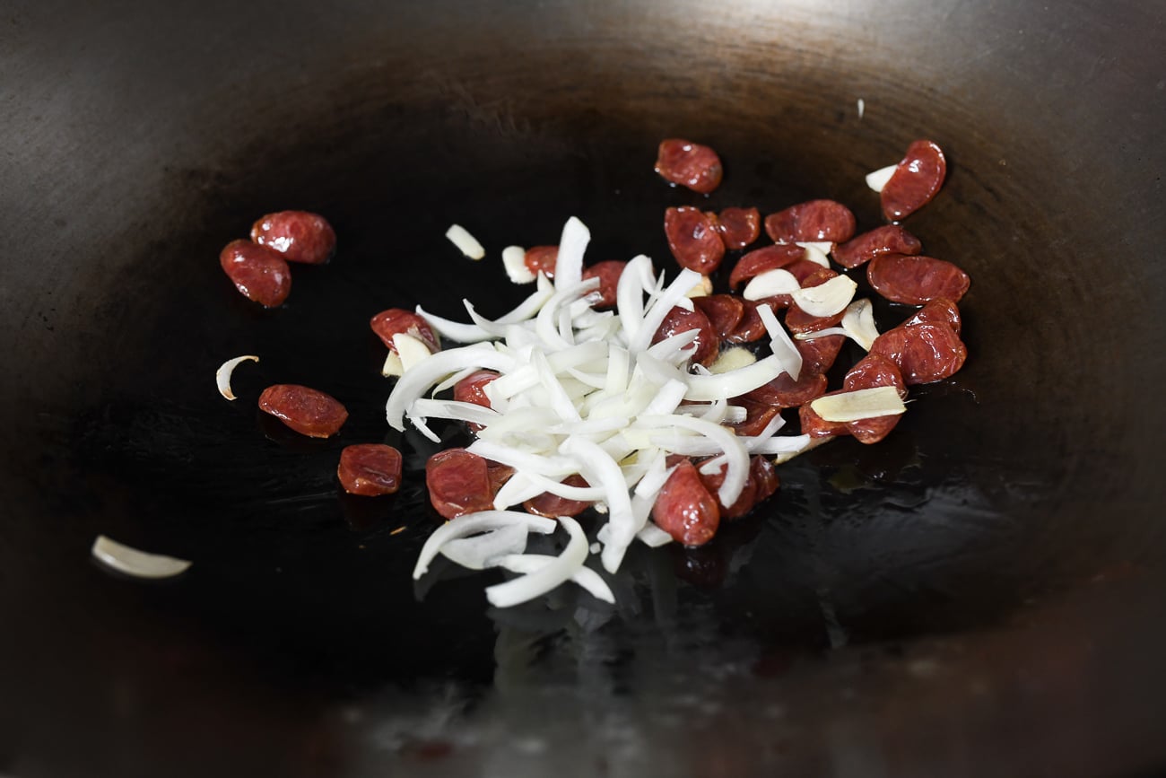 Adding onions to Chinese sausage