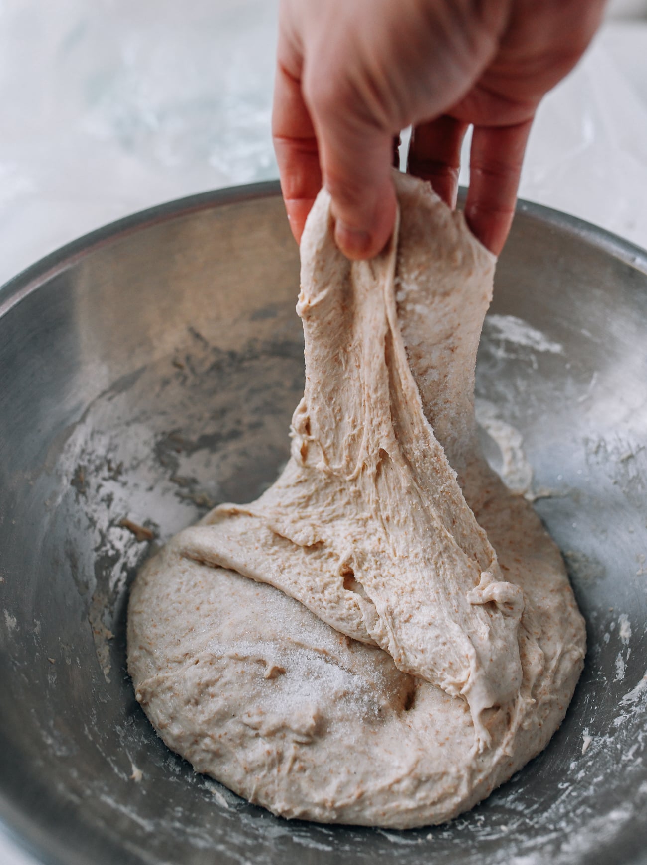 Stretching and folding dough to incorporate salt
