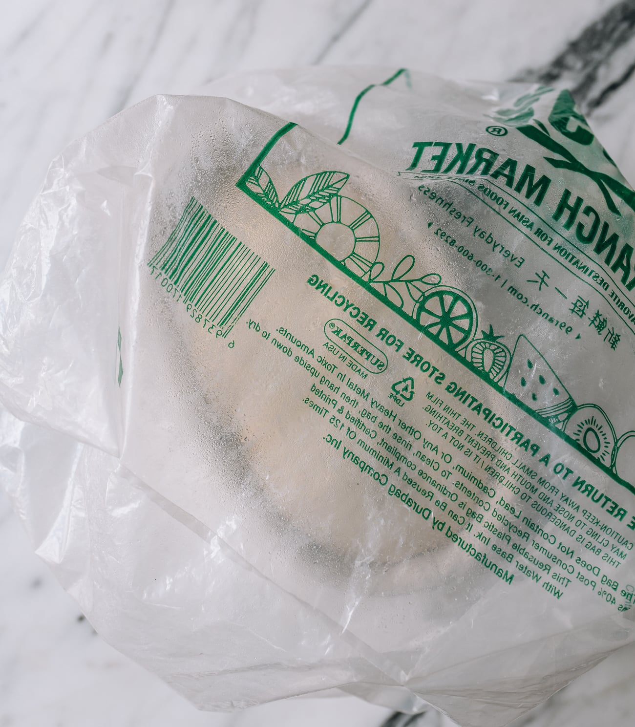 Sourdough in banneton, covered with proofing bag