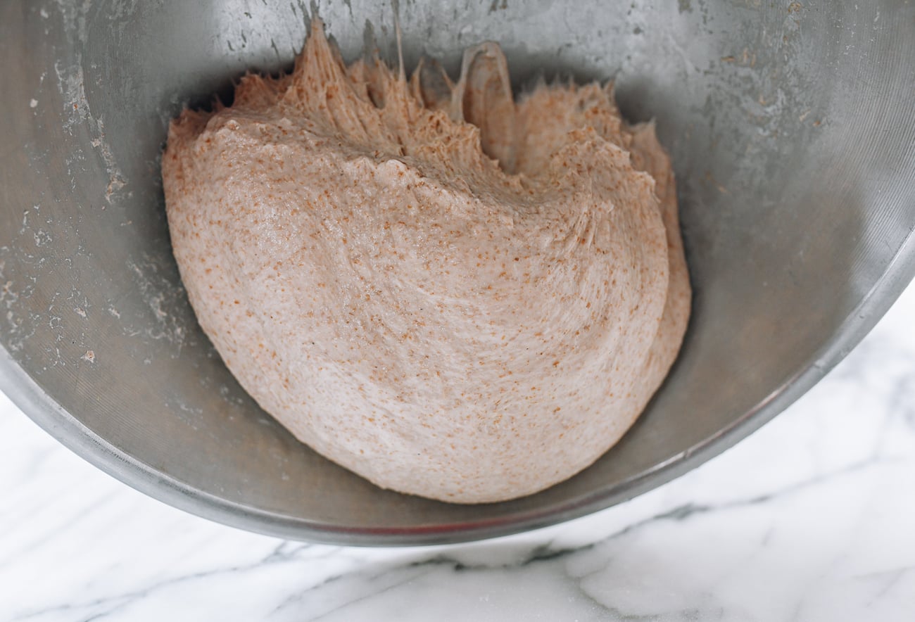 Letting dough fall slowly out of bowl onto counter