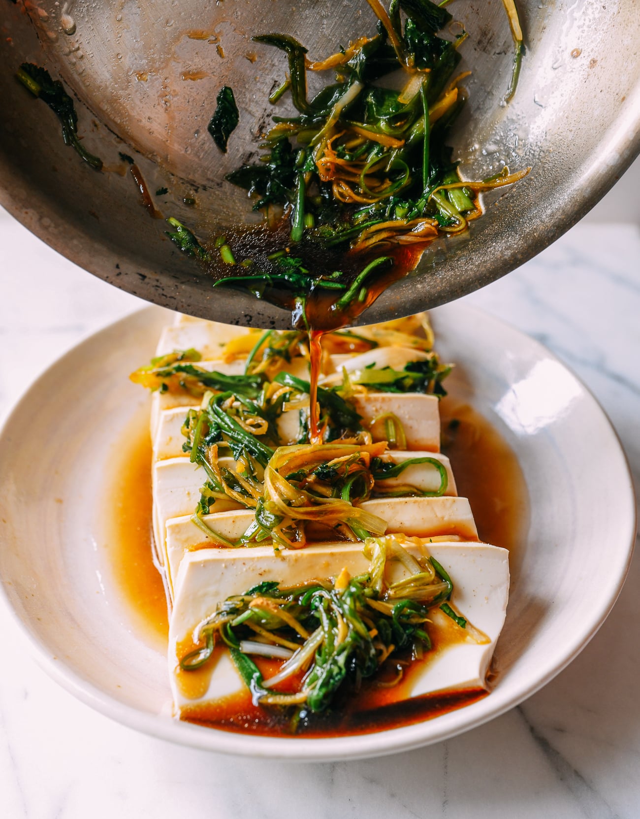 Pouring sauce over tofu